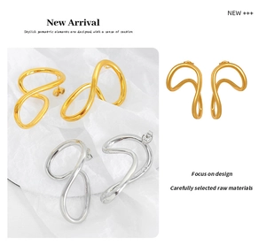 Detail view of twisted geometric hoop earrings in polished 18K gold and silver finishes