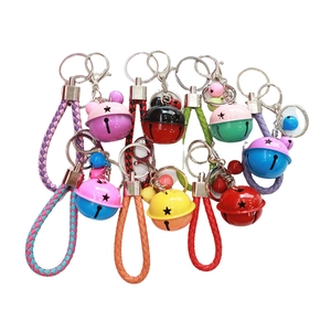 Colorful bell keychains with star cutouts and braided ropes on a white background