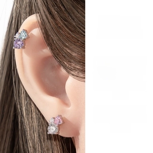 Detail of zircon cartilage piercings in heart and geometric shapes for women