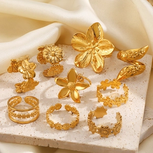 9-piece 18k gold plated stainless steel flower ring set on a natural stone slab