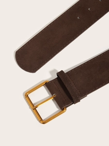 Close-up of wide brown suede belt with polished gold metal buckle and matte texture