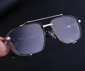Detailed macro shot of silver metal sunglasses frame with intricate textured engraving