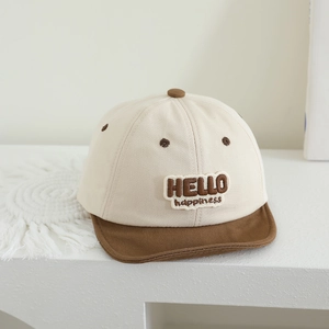 Detail of baby baseball cap with HELLO happiness embroidery on breathable canvas fabric