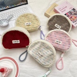 Set of five plush shell-shaped cosmetic bags with lamb wool texture and zipper straps