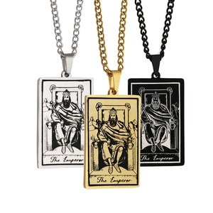 Detailed view of tarot card pendants in gold, silver, and black with The Emperor design
