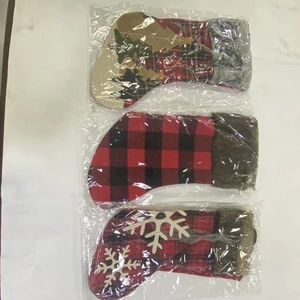 Close-up of plaid Christmas stockings with snowflake and reindeer embroidery details