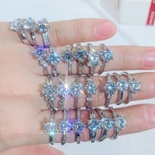 Detailed view of silver rings featuring round brilliant cut cubic zirconia in prong setting