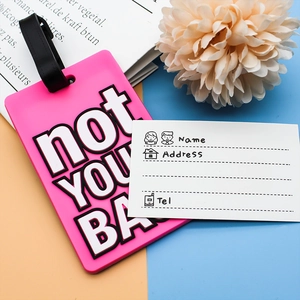 Pink PVC luggage tag with 'not YOUR BAG' text, black silicone strap and ID info card