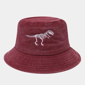 Detail of white dinosaur skeleton embroidery on burgundy washed cotton bucket hat