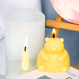 Detail of 3D bear candle silicone mold with a finished yellow teddy bear candle