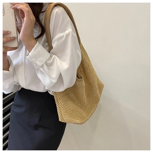 Detailed close-up of beige woven texture and hollow mesh design on a summer tote bag