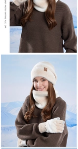 Detail view of beige winter knit set including beanie, scarf and gloves in snow scene