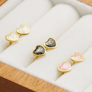 Three pairs of heart-shaped glitter earrings in white, black, and pink with 18K gold plating