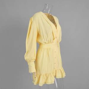 Detail of light yellow V-neck dress featuring front buttons and a ruffled hemline