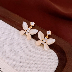 Detail of elegant butterfly stud earrings with cat's eye stones and zircon inlay