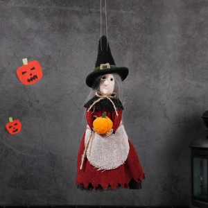 Hanging Halloween witch decoration with red dress and orange pumpkin on grey background