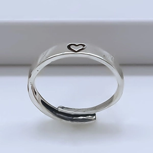Minimalist silver open heart ring with hollow heart design on a clean white background