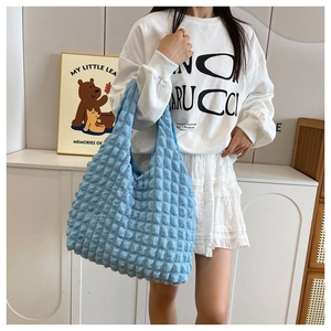 Detailed view of the blue puff cloud handbag featuring unique bubble waffle texture