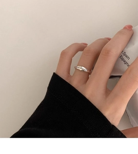 Detailed close-up of S925 silver smile ring featuring engraved letters on finger