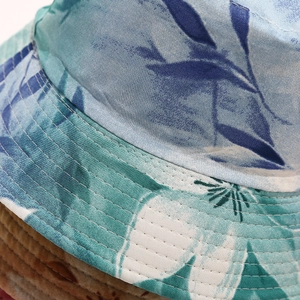 Detailed macro view of cotton bucket hat with tropical floral prints and reinforced stitching