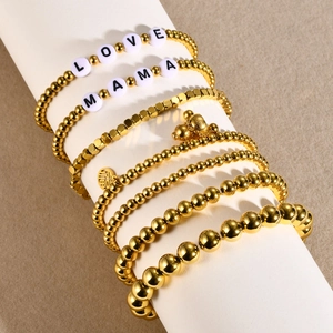 7-piece stackable 18K gold beaded bracelet set with LOVE MAMA letters and lucky charms