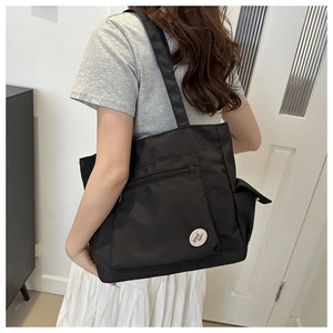 Detailed back view of a black large capacity tote bag with adjustable shoulder straps