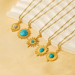 Bohemian gold stainless steel necklaces with vintage turquoise pendants on white display