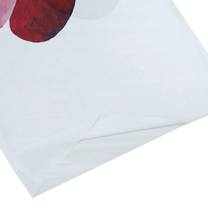 Detailed close-up of breathable mesh hemline with dark red floral print on white fabric