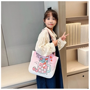 Detail of pink canvas tote bag showing cute strawberry milk and bunny graphic patterns