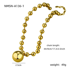 Macro shot of 2.5cm gold mirror sphere pendant on beaded chain necklace, 49g weight