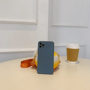 Close-up of a blue silicone iPhone Pro case next to a yellow patterned round bag