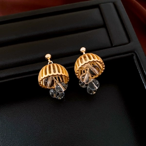 Macro view of vintage gold lantern earrings with transparent crystal glass beads