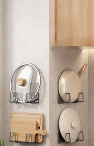 Detail showing wall-mounted gun grey kitchen rack for lids and cutting boards