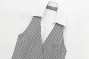 Detail shot of mini halter dress with black and white gingham pattern and white collar