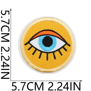 Close-up of 5.7cm round sun eye embroidered patch with detailed orange and black stitching