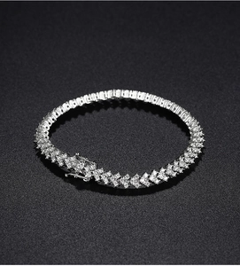 Close-up of a silver moissanite tennis bracelet with micro-pave setting on black background
