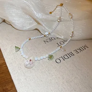 Stainless steel beaded necklace with green flower petals and a cat pattern pendant