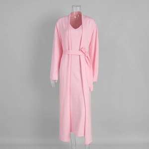 Detail of soft pink knit long dress set with a belted cardigan on a studio mannequin