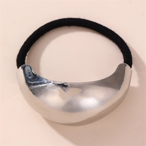 Macro shot of minimalist silver curved metal plate on a black elastic hair tie