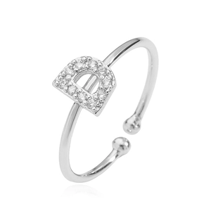 Macro shot of silver open ring featuring a sparkling micro-pave cubic zirconia D letter