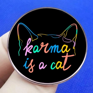 Round Karma is a Cat metal badge pin with artistic font and cat ear outlines on blue background