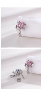 Detail of star-shaped cartilage stud with pink zircon and meteor trail silver design