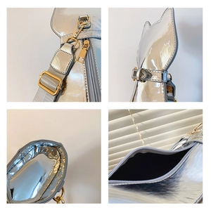 Detail view of silver mirror cat bag showing metal hooks, cat ears, and inner lining