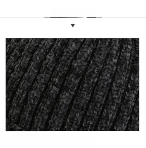 Macro detail of charcoal grey ribbed knit fabric showing soft texture and warm yarn fibers