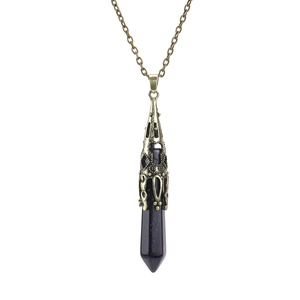 Close-up of blue sandstone hexagonal pendant with vintage filigree metal cap