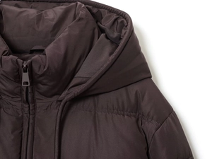 Detail shot of a dark brown hooded jacket featuring a premium zipper and quilted texture