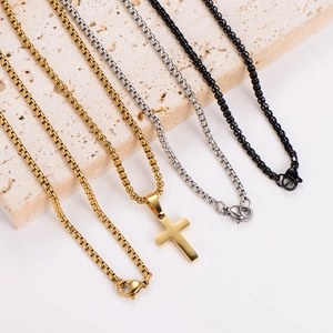Polished stainless steel necklaces in gold, silver and black with cross pendant on stone