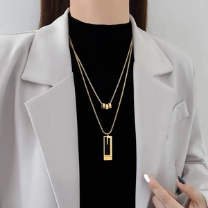 Double layered titanium steel necklace with gold cylindrical beads and rectangle pendant