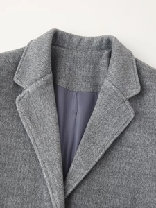 Detail of wool coat notched lapels and smooth grey satin lining texture