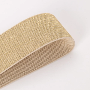 Detail of champagne gold metallic woven elastic band with high stretch and glossy finish